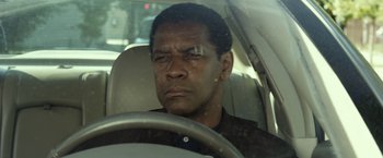 Movie still from “Flight” (2012), directed by Robert Zemeckis – A man sitting in the driver's seat of a car; Close Up shot, Over the shoulder angle