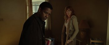 Movie still from “Flight” (2012), directed by Robert Zemeckis – A man and a woman standing next to each other in a room; Medium shot, Low angle