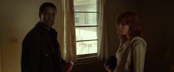 Movie still from “Flight” (2012), directed by Robert Zemeckis – A man and a woman standing in front of a window; Medium shot, Low angle