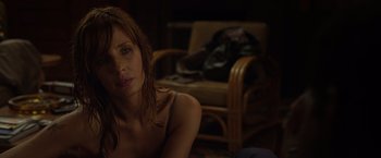 Movie still from “Flight” (2012), directed by Robert Zemeckis – A woman sitting on the ground in a room; Close Up shot, Over the shoulder angle