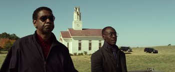 Movie still from “Flight” (2012), directed by Robert Zemeckis – Two men standing in front of an old church; Medium shot, Low angle