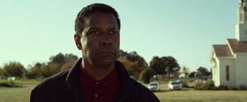 Movie still from “Flight” (2012), directed by Robert Zemeckis – A person wearing a jacket near some trees; Close Up shot, Low angle