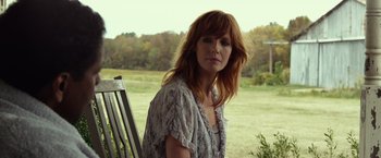 Movie still from “Flight” (2012), directed by Robert Zemeckis – A woman sitting on top of a wooden bench; Close Up shot, Low angle