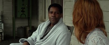 Movie still from “Flight” (2012), directed by Robert Zemeckis – A man wrapped in a towel sitting on a porch; Close Up shot, Over the shoulder angle
