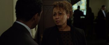 Movie still from “Flight” (2012), directed by Robert Zemeckis – An older woman is crying while talking to a younger man; Close Up shot, Over the shoulder angle