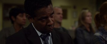 Movie still from “Flight” (2012), directed by Robert Zemeckis – A man in a suit and tie looking sad; Close Up shot, Over the shoulder angle