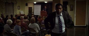Movie still from “Flight” (2012), directed by Robert Zemeckis – A man standing in front of an audience; Medium shot, Over the shoulder angle