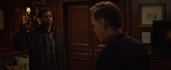 Movie still from “Flight” (2012), directed by Robert Zemeckis – Two men are standing in front of each other in a room; Medium shot, Over the shoulder angle