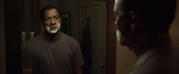 Movie still from “Flight” (2012), directed by Robert Zemeckis – A man with a shaving foam on his face; Medium shot, Over the shoulder angle