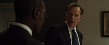 Movie still from “Flight” (2012), directed by Robert Zemeckis – A man in a suit and tie talking to another man; Close Up shot, Over the shoulder angle