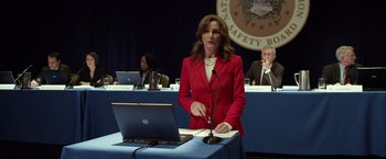 Movie still from “Flight” (2012), directed by Robert Zemeckis – A woman in a red jacket standing in front of a laptop; Medium shot, Over the shoulder angle