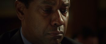Movie still from “Flight” (2012), directed by Robert Zemeckis – A man's face with tears in his eyes; Close Up shot, Low angle