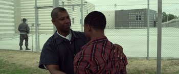 Movie still from “Flight” (2012), directed by Robert Zemeckis – A man and a young man are talking to each other; Medium shot, Over the shoulder angle