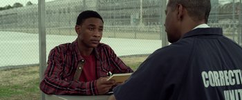 Movie still from “Flight” (2012), directed by Robert Zemeckis – A man sitting in front of another man holding a notepad; Close Up shot, Over the shoulder angle