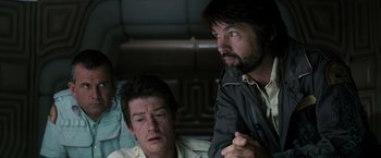 Movie still from “Alien” (1979), directed by Ridley Scott – Two men sitting next to each other in a room; Close Up shot, Over the shoulder angle