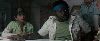 Movie still from “Alien” (1979), directed by Ridley Scott – A man sitting at a table wearing a blue headband; Close Up shot, Over the shoulder angle