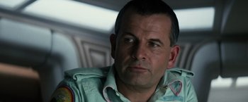 Movie still from “Alien” (1979), directed by Ridley Scott – A person wearing a green shirt; Close Up shot, Low angle