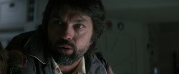 Movie still from “Alien” (1979), directed by Ridley Scott – A person with long hair and a beard; Close Up shot, Low angle