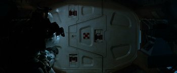 Movie still from “Alien” (1979), directed by Ridley Scott – An overhead view of a person in a space suit; Medium shot, Overhead angle