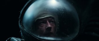 Movie still from “Alien” (1979), directed by Ridley Scott – A man in a helmet looking into a mirror; Close Up shot, Overhead angle