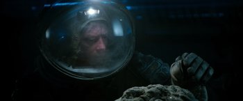 Movie still from “Alien” (1979), directed by Ridley Scott – A man in a space suit looking into a mirror; Close Up shot, Overhead angle