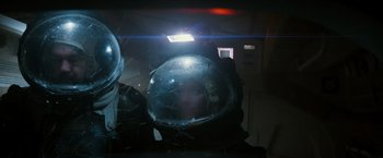Movie still from “Alien” (1979), directed by Ridley Scott – A person wearing a helmet with a light shining on it; Medium shot, Overhead angle
