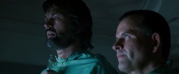 Movie still from “Alien” (1979), directed by Ridley Scott – Two men are looking at each other in a dark room; Close Up shot, Low angle