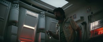 Movie still from “Alien” (1979), directed by Ridley Scott – A man holding a wii controller in a room; Medium shot, Low angle