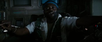 Movie still from “Alien” (1979), directed by Ridley Scott – A man with a beard and a blue hat is smiling; Close Up shot, Overhead angle