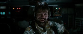 Movie still from “Alien” (1979), directed by Ridley Scott – A man with a beard is smiling for the camera; Close Up shot, Low angle