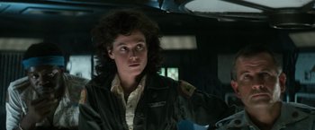 Movie still from “Alien” (1979), directed by Ridley Scott – A woman in a military jacket looking to her left; Close Up shot, Low angle