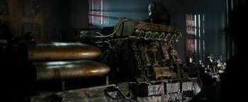 Movie still from “Alien” (1979), directed by Ridley Scott – An old machine is sitting in a dark room; Wide shot, Low angle