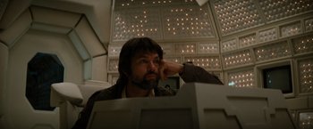 Movie still from “Alien” (1979), directed by Ridley Scott – A man sitting in front of a computer monitor; Close Up shot, Low angle