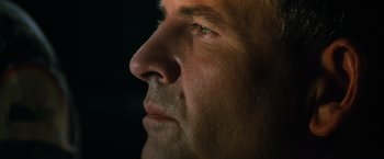 Movie still from “Alien” (1979), directed by Ridley Scott – A man's face in the dark; Extreme Close Up shot, Low angle