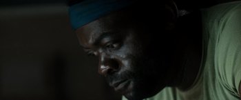 Movie still from “Alien” (1979), directed by Ridley Scott – A man's face in a dark room; Extreme Close Up shot, Low angle