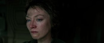 Movie still from “Alien” (1979), directed by Ridley Scott – A person's face in a dark room; Close Up shot, High angle