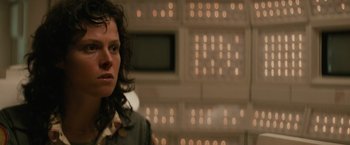 Movie still from “Alien” (1979), directed by Ridley Scott – A woman standing in front of a wall of lights; Close Up shot, Low angle