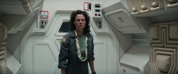 Movie still from “Alien” (1979), directed by Ridley Scott – A woman standing in a room next to a wall; Medium shot, Low angle