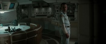 Movie still from “Alien” (1979), directed by Ridley Scott – A man in uniform standing in a kitchen; Medium shot, Over the shoulder angle