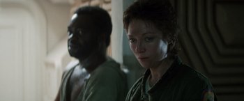 Movie still from “Alien” (1979), directed by Ridley Scott – A woman standing next to a black man in a room; Close Up shot, Over the shoulder angle