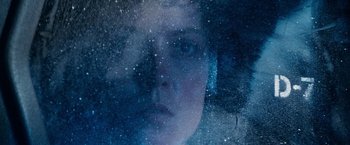 Movie still from “Alien” (1979), directed by Ridley Scott – A woman looking out of a window at the stars; Extreme Close Up shot, Overhead angle