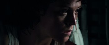 Movie still from “Alien” (1979), directed by Ridley Scott – A person's face in the dark; Close Up shot, Low angle