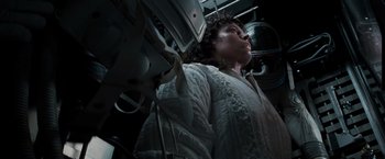 Movie still from “Alien” (1979), directed by Ridley Scott – A woman in a white jacket is looking up; Medium shot, Low angle