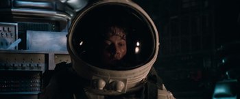Movie still from “Alien” (1979), directed by Ridley Scott – A young boy in a space suit looking at the camera; Close Up shot, Overhead angle