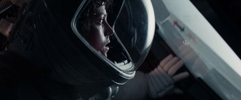 Movie still from “Alien” (1979), directed by Ridley Scott – A man wearing a space helmet looking into a mirror; Close Up shot, Overhead angle