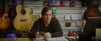 Movie still from “Flora and Son” (2023), directed by John Carney – Medium shot, Low angle