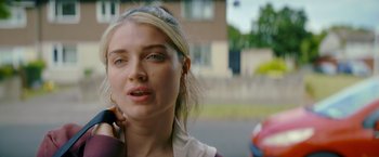 Movie still from “Flora and Son” (2023), directed by John Carney – A woman talking on a cell phone while standing on a street; Close Up shot, Over the shoulder angle