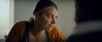 Movie still from “Flora and Son” (2023), directed by John Carney – A person looking at a camera; Close Up shot, Over the shoulder angle