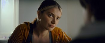 Movie still from “Flora and Son” (2023), directed by John Carney – A beautiful young lady looking at the camera; Close Up shot, Over the shoulder angle