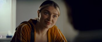 Movie still from “Flora and Son” (2023), directed by John Carney – A person wearing a yellow jacket; Close Up shot, Over the shoulder angle